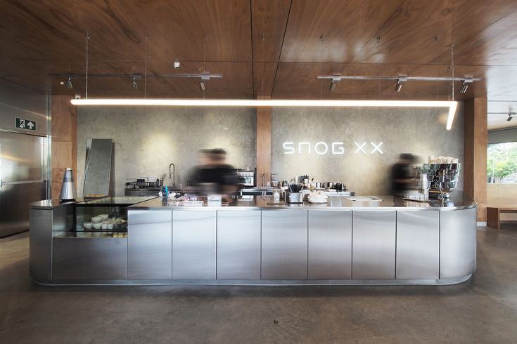 Sleek and Modern Cafe Design: Minimalist Aesthetics with Stainless Steel and Warm Wood Accents