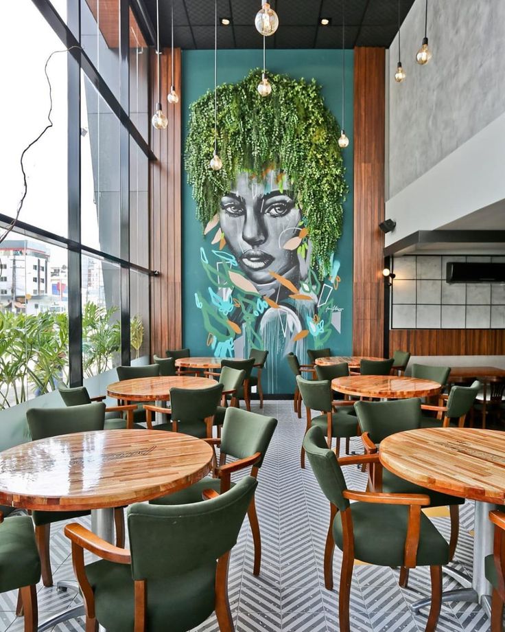 Modern Cafe with Striking Mural and Inviting Ambiance Ideal for Gatherings and Reflection