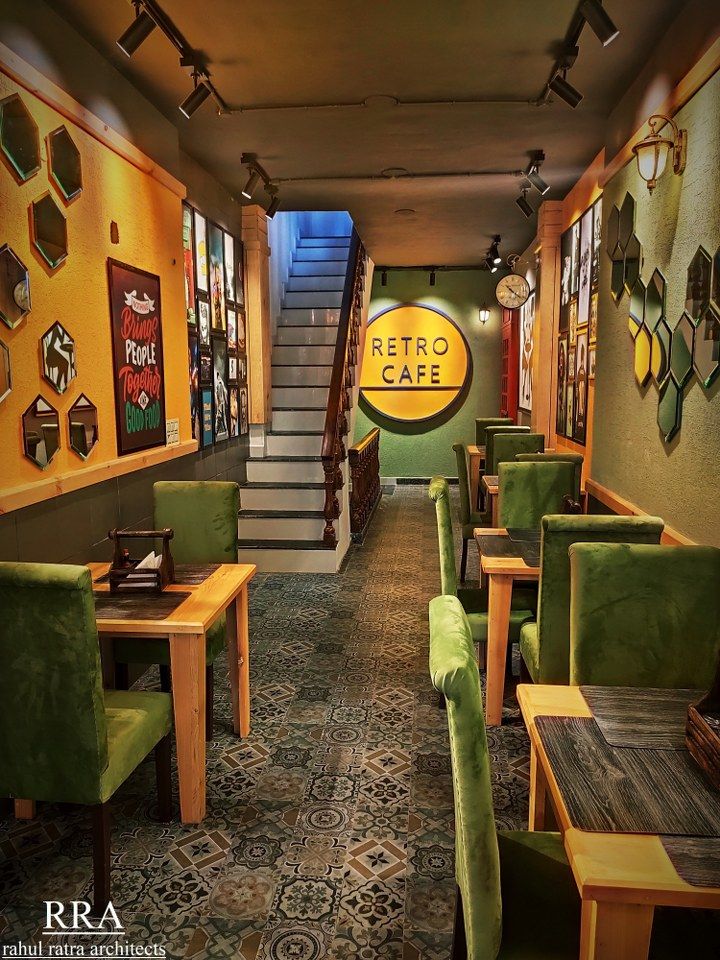 Cozy and Inviting Cafe Design Blends Contemporary and Retro Elements with Warm Colors and Artful Decor