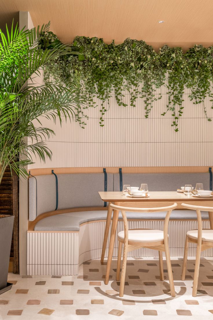 Cozy Modern Cafe Design Harmonizes Comfort and Style with Greenery and Light Wood Accents