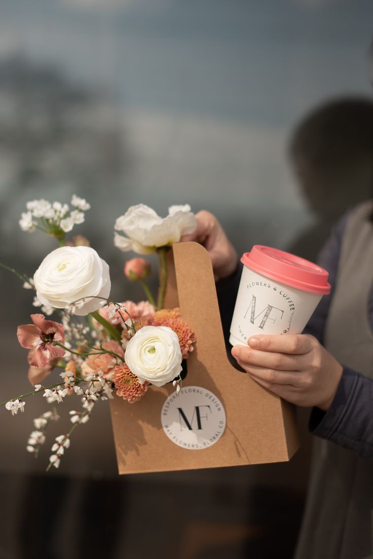 A Warm and Inviting Cafe Atmosphere Embracing Fresh Flowers and To-Go Coffee