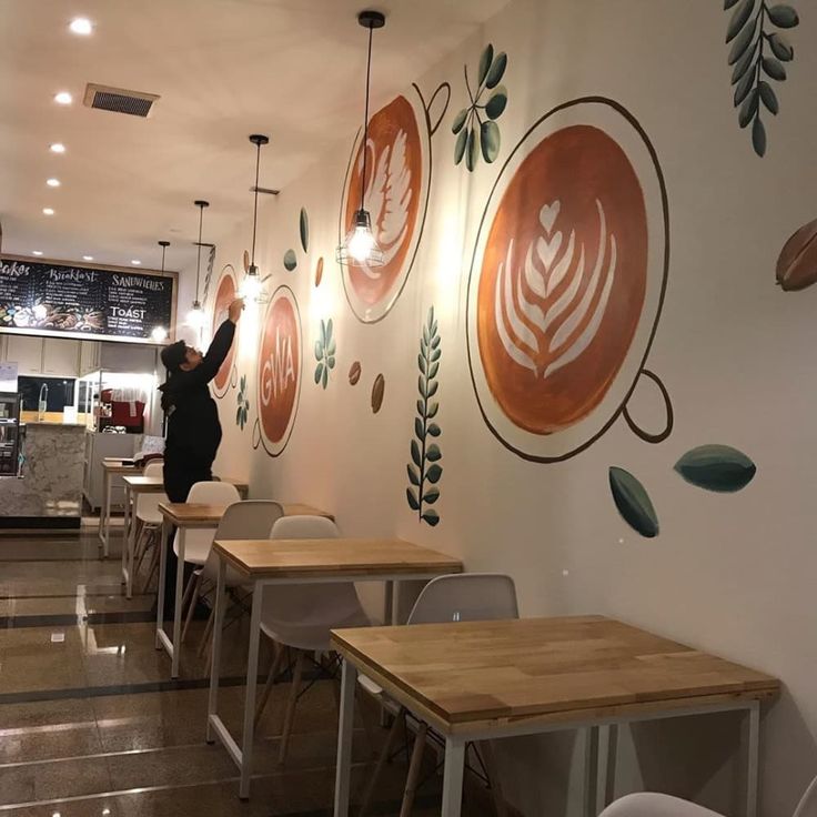 Cozy Cafe Design: Artistic Mural, Warm Ambiance, and Inviting Atmosphere for Coffee Lovers