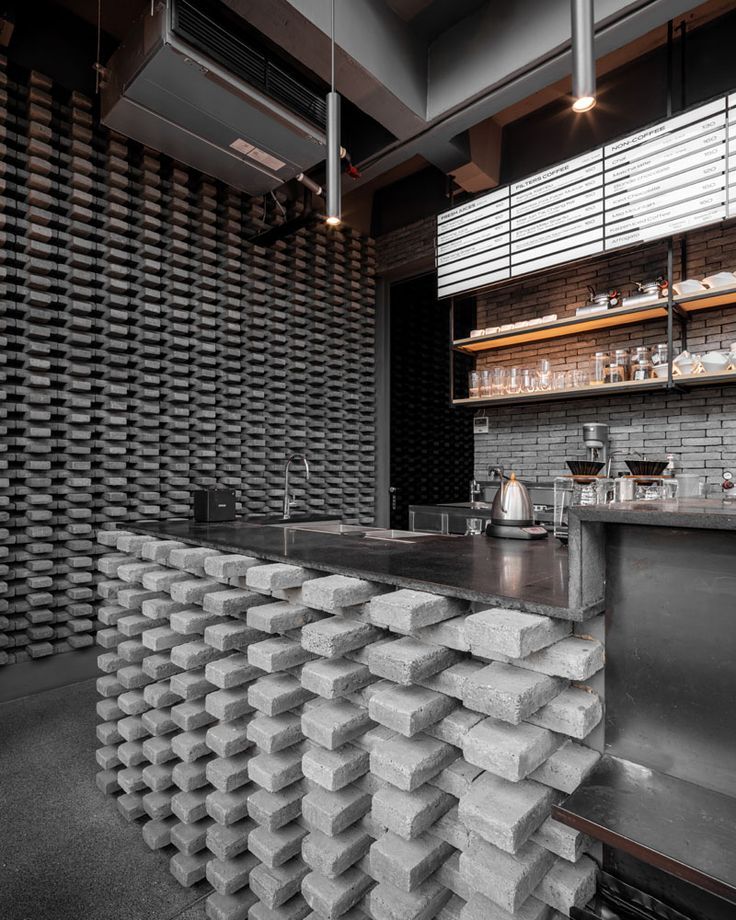 Modern Cafe Design Balances Industrial and Minimalist Elements with Unique Bar Structure