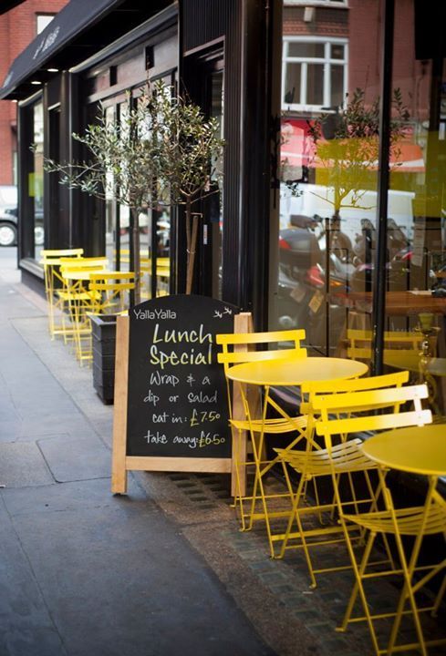 Charming Cafe Design Blends Vibrant Outdoor Seating with Rustic Touches for Inviting Atmosphere