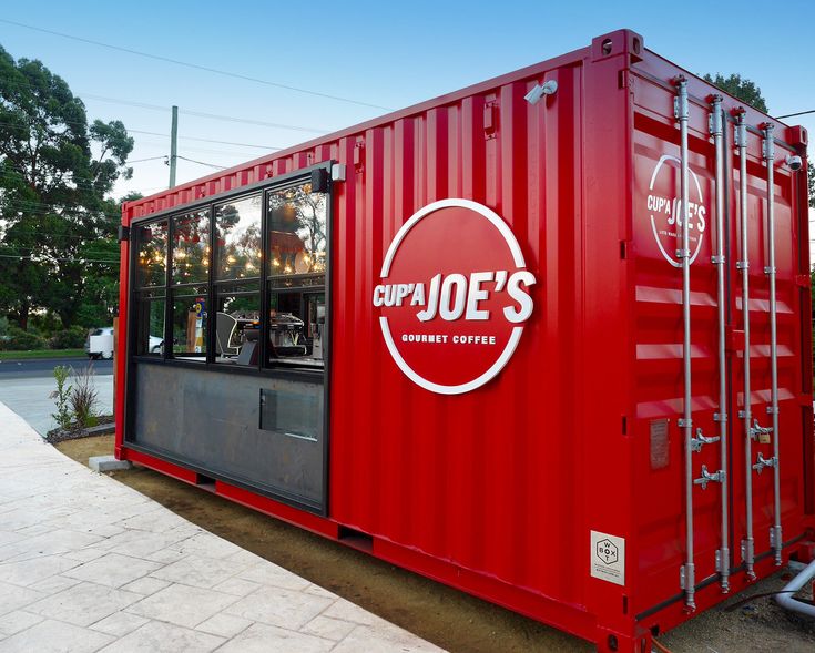 Vibrant Red Shipping Container Cafe with Modern Design and Inviting Patio Atmosphere