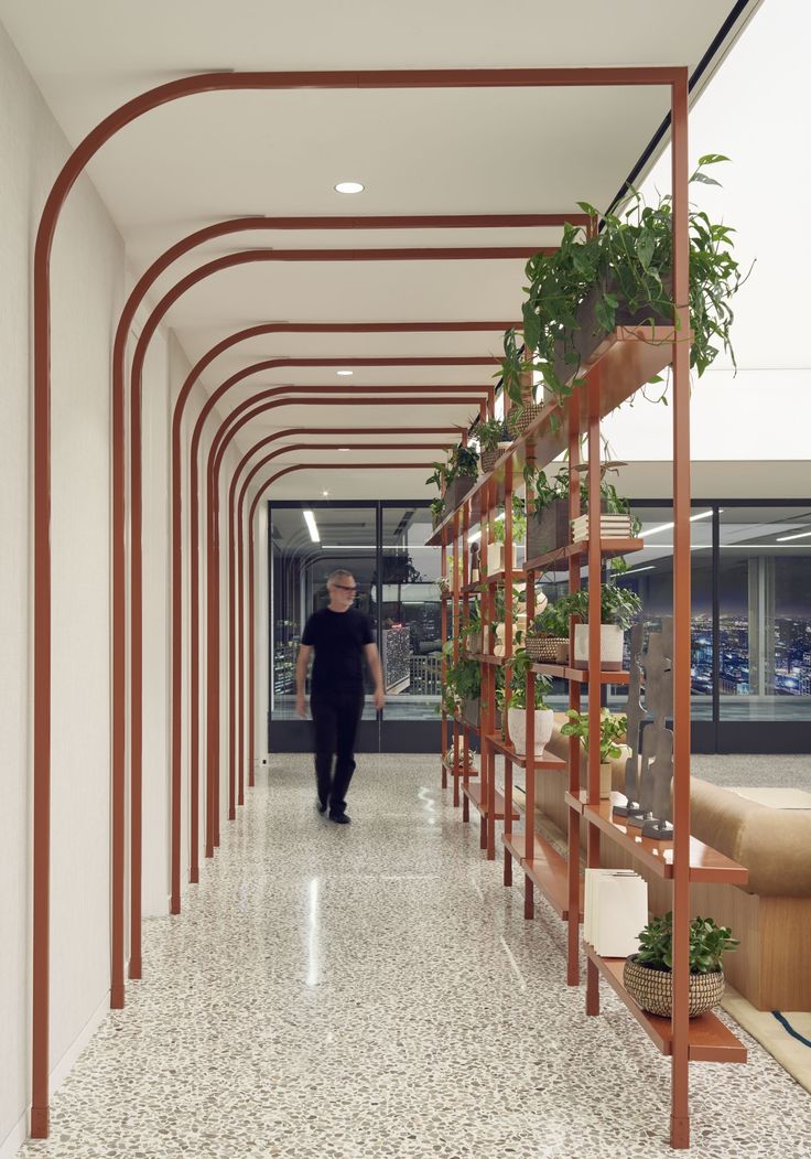 Modern Minimalist Cafe Design: Curved Metal Arches and Lush Greenery Foster Airy Ambiance and Social Connection