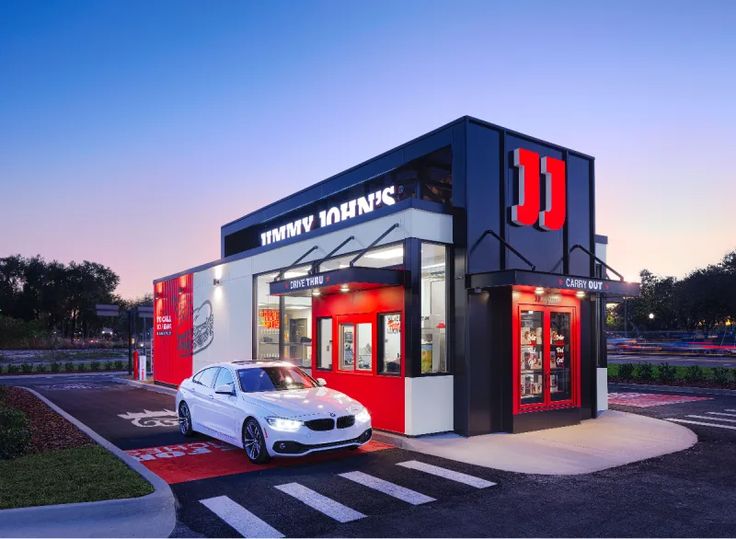 Modern Cafe Design: Striking Red and Black Architecture with Inviting Atmosphere and Welcoming Landscaping