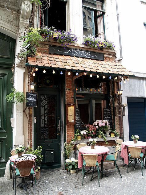 Charming Cafe with Rustic Facade and Cozy Outdoor Seating Embraces European Ambiance