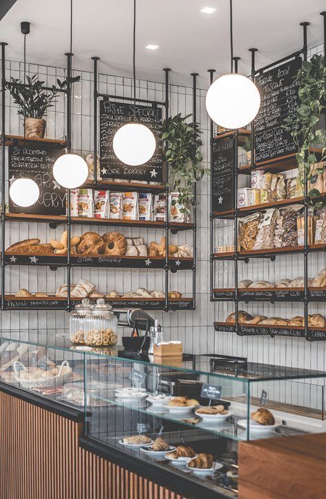 Modern Cafe Design: A Warm, Inviting Space with Industrial Aesthetics and Baked Goods Display