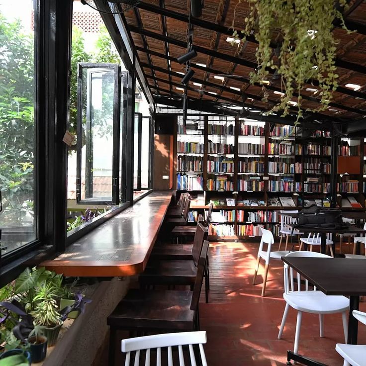 Modern Cafe Blends Natural Light, Cozy Bookshelves, and Rustic Charm for a Bright Social Space