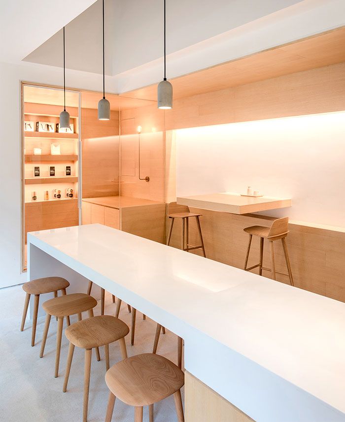 Minimalist Cafe Design: Inviting Space with Warm Wood Tones and Elegant Lighting