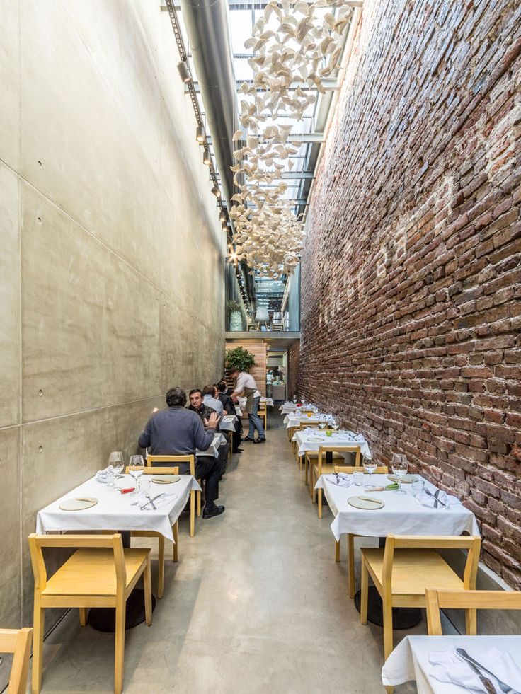 Contemporary Cafe Design Blends Exposed Brick with Sleek Concrete and Whimsical Lighting