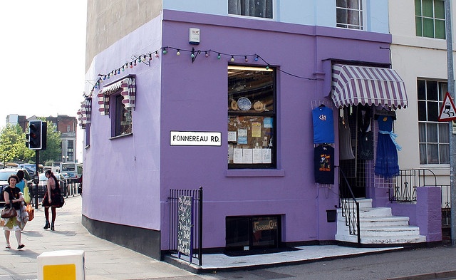 Charming Cafe with Vibrant Purple Exterior and Inviting Atmosphere