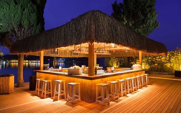 Tropical-Inspired Cafe Features Cozy Outdoor Bar and Elegant Natural Ambiance