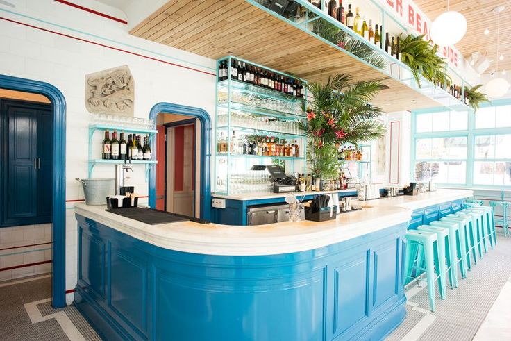 Vibrant Coastal Cafe Design Featuring a Blue Bar and Tropical Aesthetics