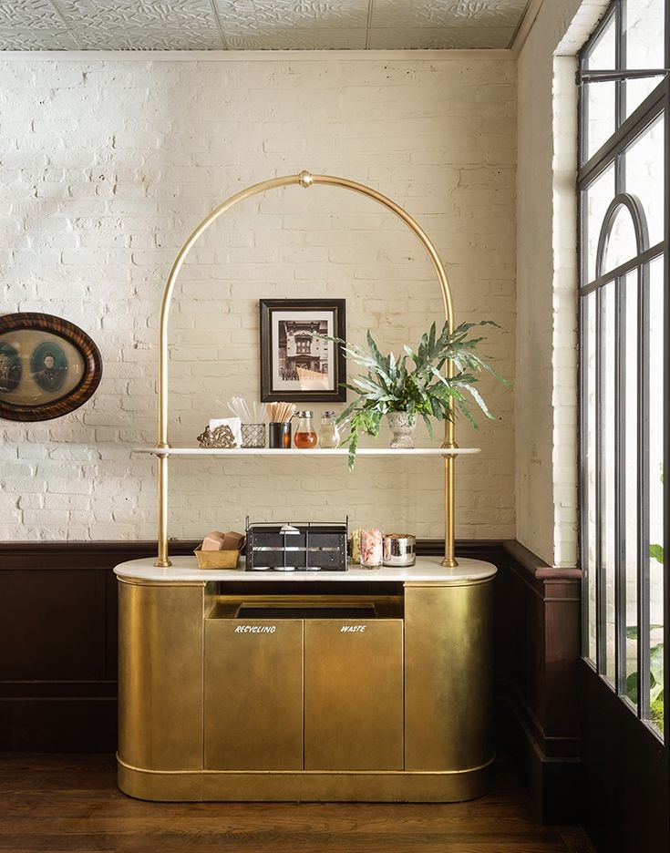 Elegant Brass Counter and Inviting Design Create a Tranquil Cafe Atmosphere