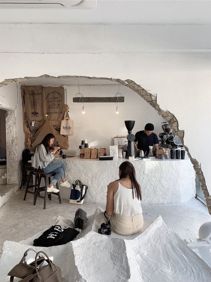 Modern Cafe with Unfinished Wall Design Creates Unique Social Atmosphere