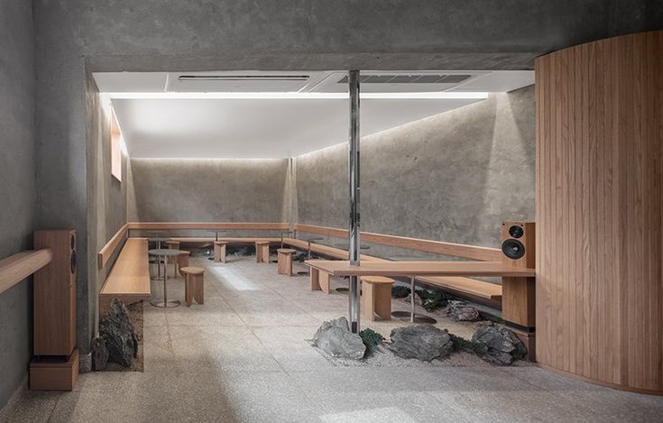 Minimalist Cafe Design: A Serene Urban Retreat with Communal Seating and Natural Accents