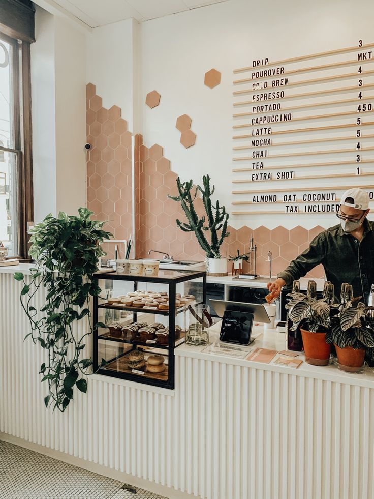 Bright and Modern Cafe Design Featuring Honeycomb Tiles and Inviting Natural Elements