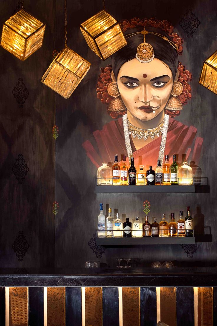 Cultural Elegance: A Cozy Cafe Interior Featuring Striking Murals and Thoughtful Lighting