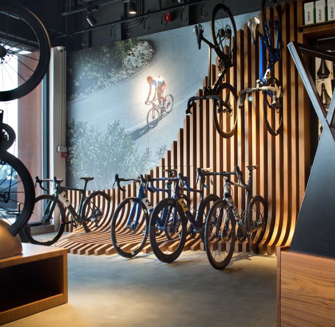 Cafe Features Modern Design with Wavy Wooden Wall and Cycling Decor for an Inviting Atmosphere