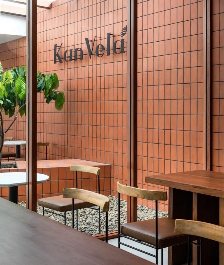 Inviting Cafe Design with Warm Terracotta Walls and Natural Light Integration