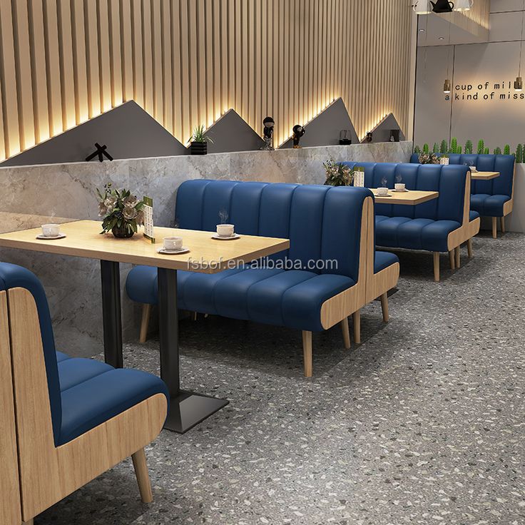 Contemporary Cafe Design with Cozy Blue Seating, Wooden Accents, and Modern Aesthetic