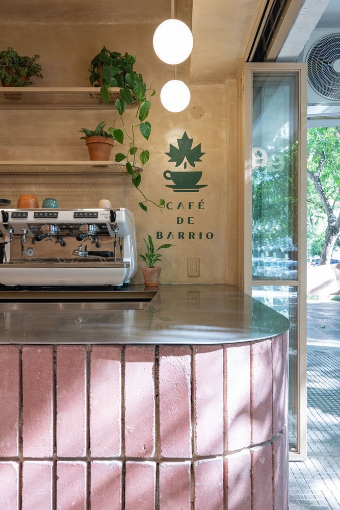 Charming Modern Cafe Design: Textured Brick Counter, Greenery, and Inviting Ambiance