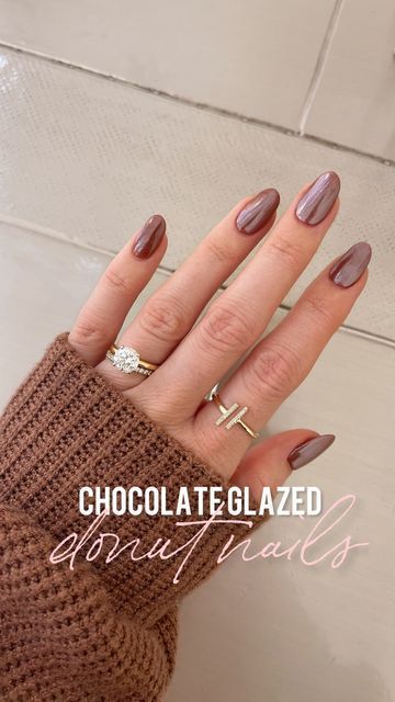 Chic Elegance: Manicured Chocolate Nails and Glamorous Accents in a Cozy Cafe Atmosphere