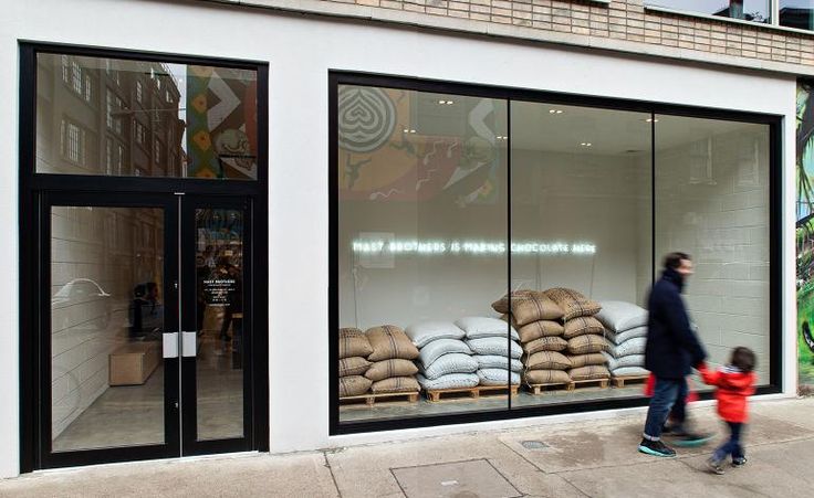 Contemporary Cafe Design: A Welcoming Space with Natural Light, Minimalist Aesthetics, and Industrial Touches