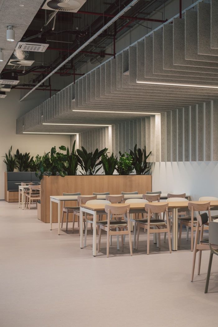 Modern minimalist cafe design with spacious interior, inviting atmosphere, strategic greenery, and stylish acoustic elements for a comfortable dining