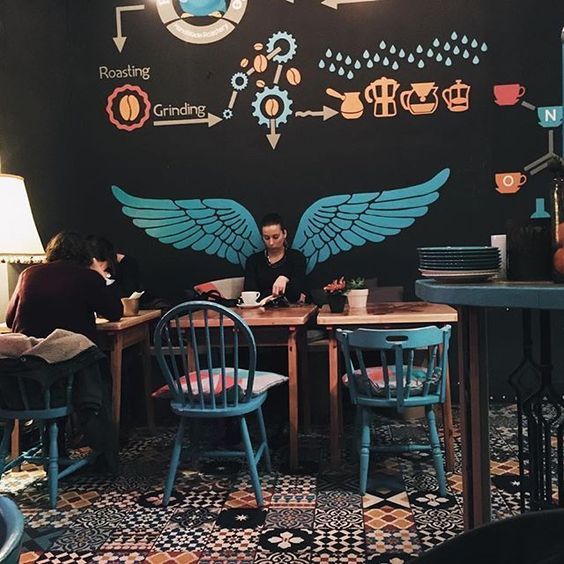 Charming Cafe with Artistic Mural and Cozy Ambiance Creates a Unique Coffee Experience