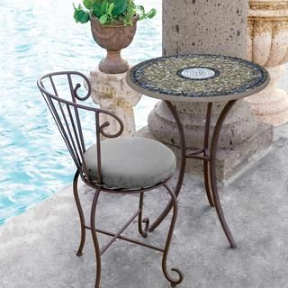 Elegant Outdoor Cafe Design with Mosaic Table, Cushioned Chair, and Tranquil Water Feature