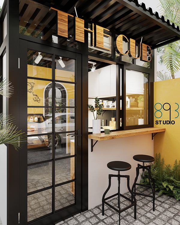 Modern Cafe Design: A Striking Blend of Black, Yellow, and Natural Elements for Cozy Chic Ambiance