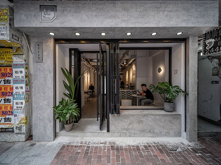 Modern Cafe Blends Minimalist Design with Inviting Greenery and Cozy Ambiance