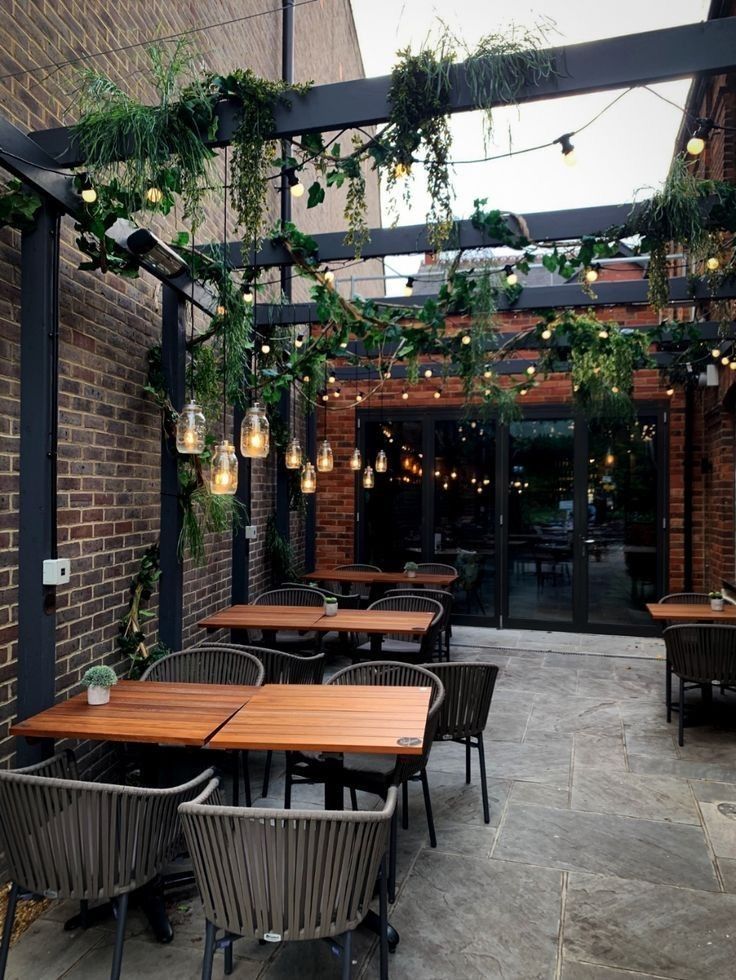 Inviting Rustic-Modern Cafe Design with Enchanting Outdoor Space and Cozy Atmosphere