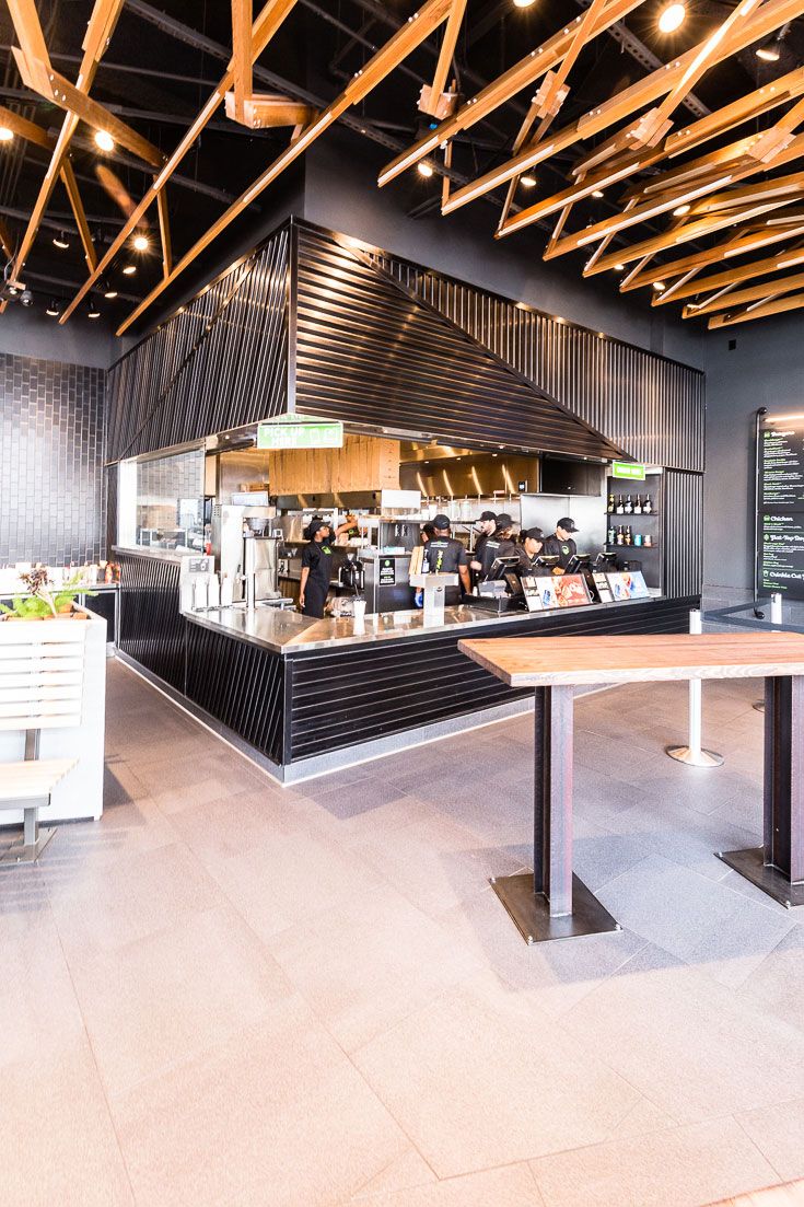 Modern Cafe Design: A Harmonious Blend of Sleek Black Paneling and Warm Wooden Accents