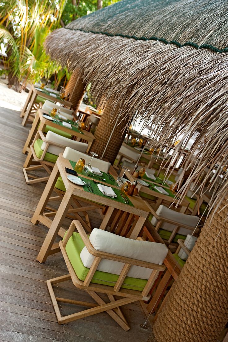 Tropical-Inspired Cafe Design: Inviting Ambiance with Rustic Elegance and Natural Comfort