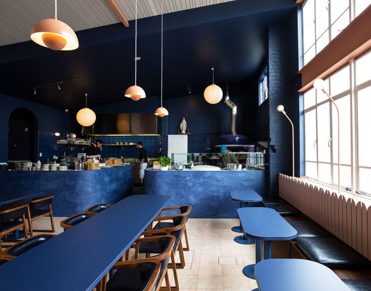 Modern Minimalist Cafe Design: A Calming Oasis of Navy Hues and Natural Light