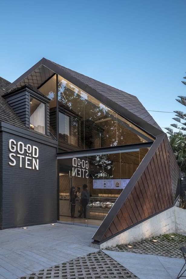 Modern Cafe Design Blends Angled Facade with Sustainable Aesthetics and Greenery