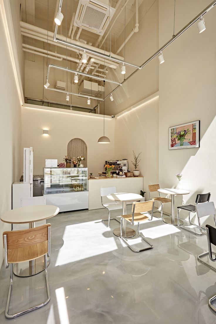 Modern Minimalist Cafe: Inviting Atmosphere with Natural Light and Industrial Charm