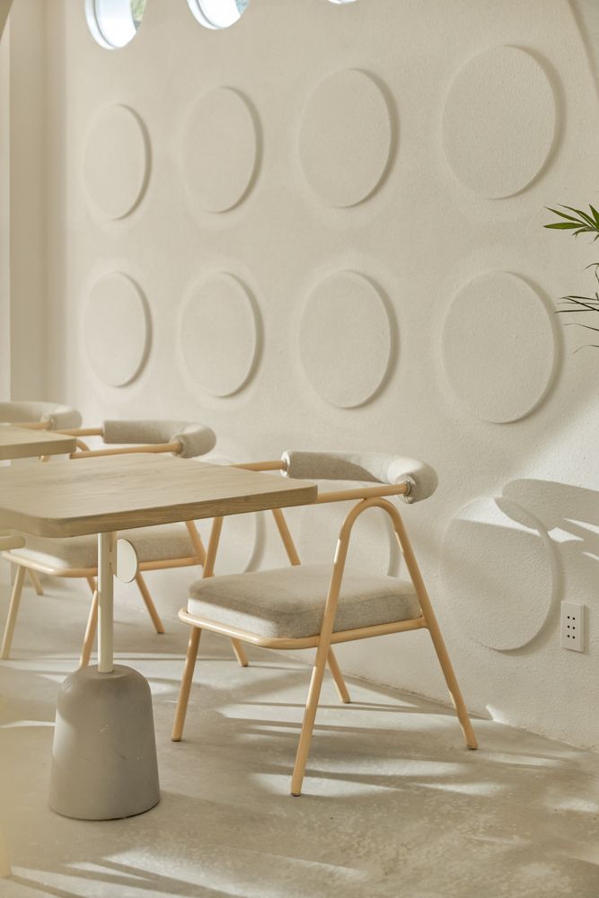 Minimalist Cafe Design: Inviting Atmosphere with Circular Patterns and Soft Lighting