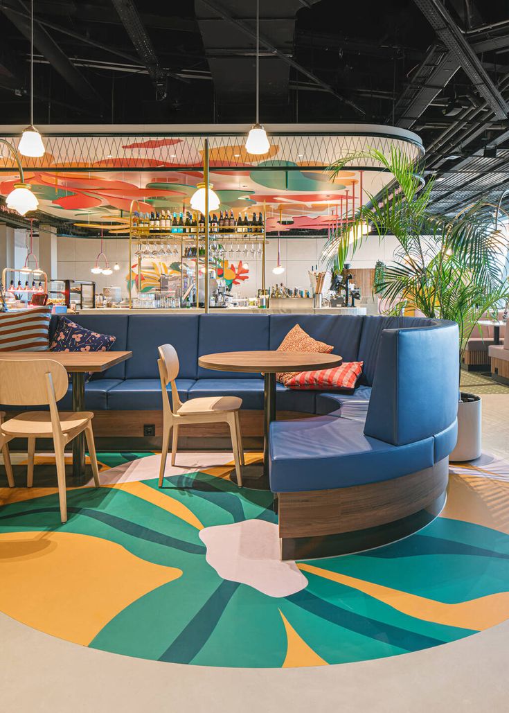 Vibrant Cafe Design: A Colorful Floral Motif and Cozy Contemporary Aesthetic