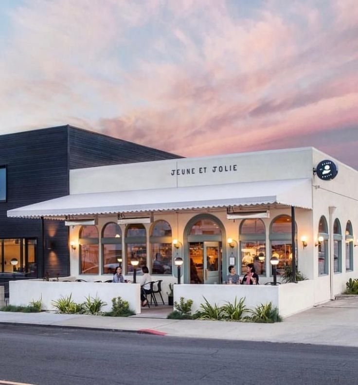 Charming Cafe Design: A Welcoming Atmosphere Enhanced by Elegant Architecture and Colorful Dusk Skies