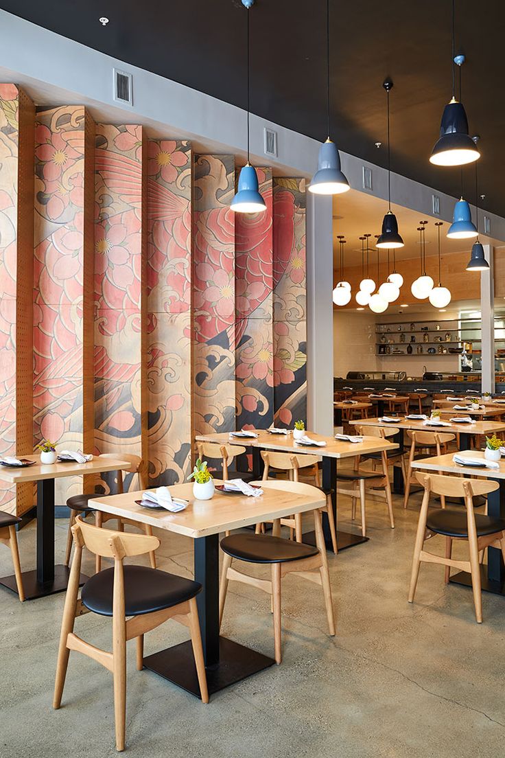 Modern Cafe Design: A Warm, Inviting Space with Striking Murals and Natural Elements