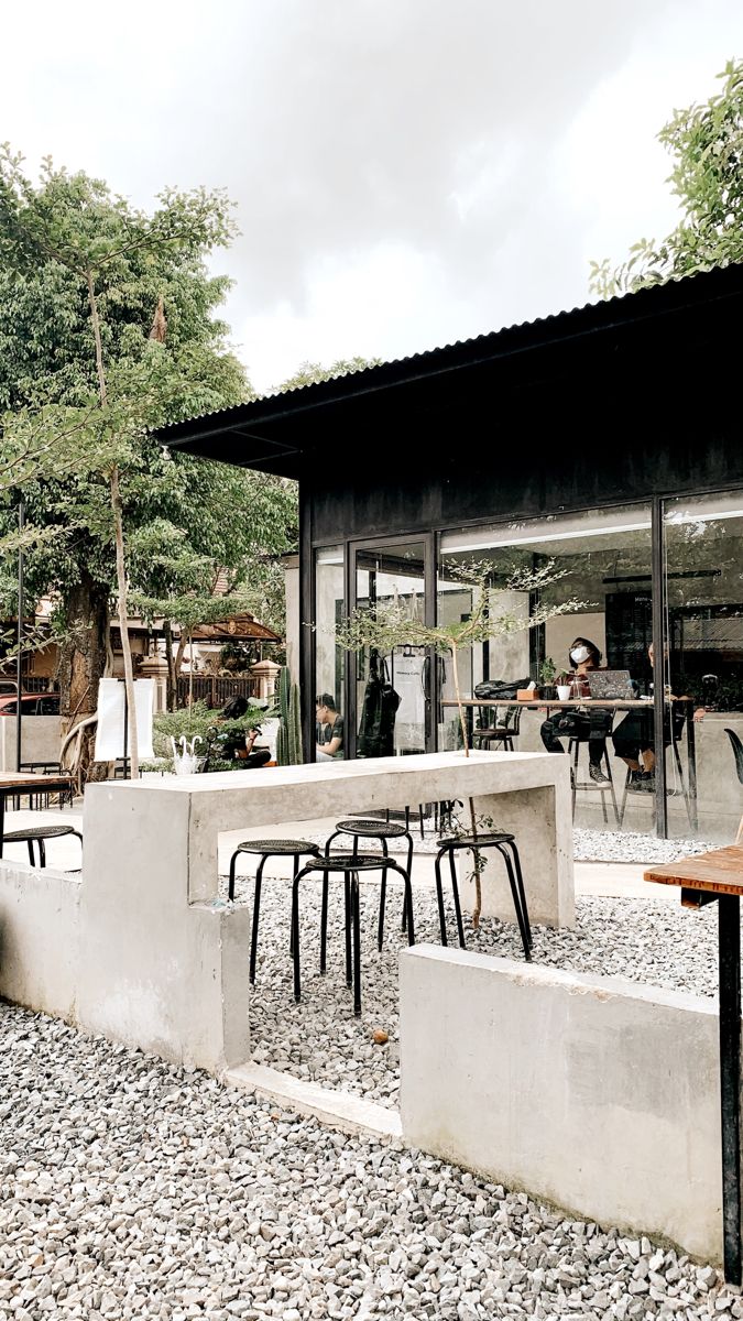 Modern Minimalist Cafe Seamlessly Blends Nature with Contemporary Design