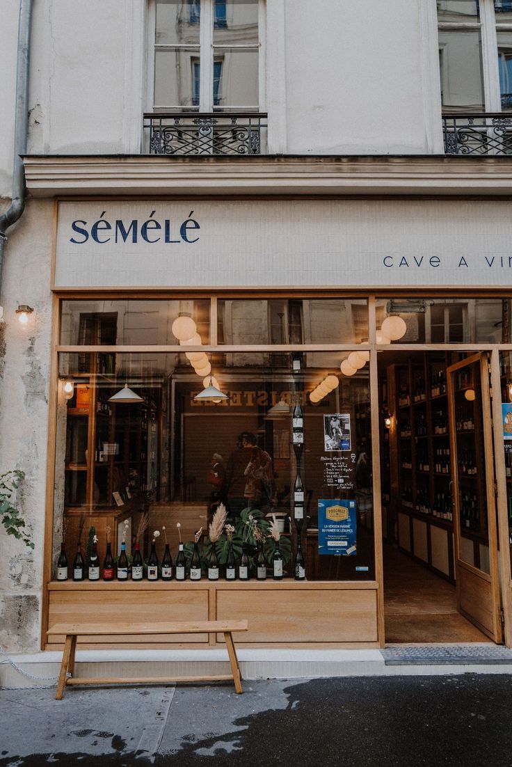 Charming Cafe Design Blends Modern Minimalism with Rustic Elements, Featuring Inviting Glass Facade and Wine Focus