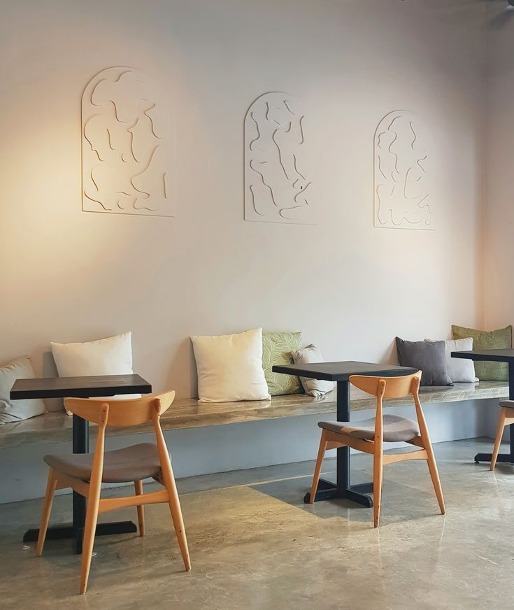 Serene Minimalist Cafe Design with Elegant Reliefs and Inviting Comfort