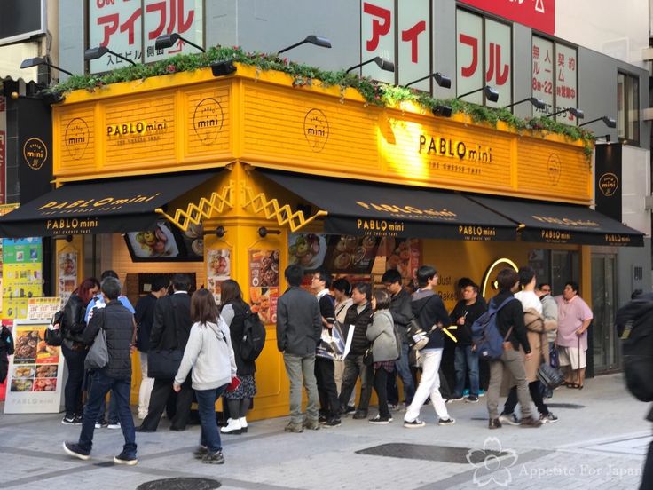 Vibrant Cafe Boasts Striking Yellow Facade and Inviting Outdoor Atmosphere