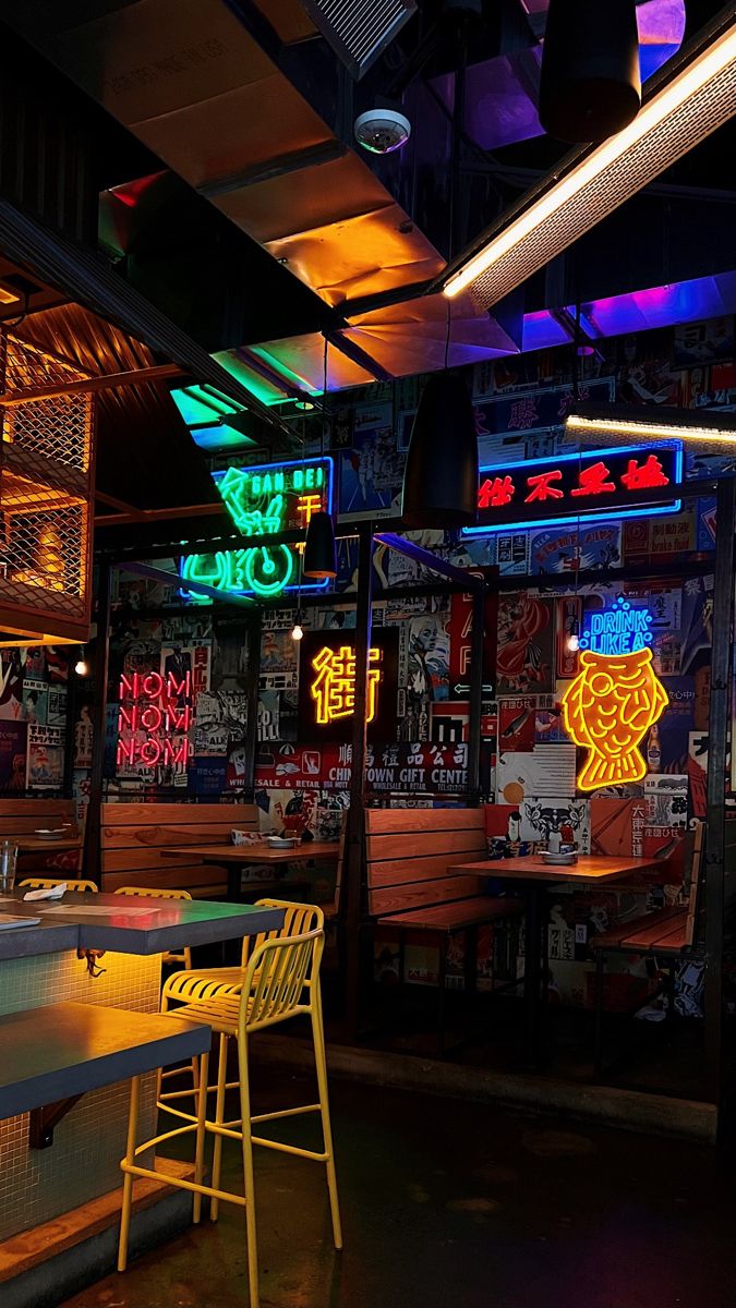 Eclectic Cafe Design Blends Vibrant Neon, Cozy Ambiance, and Rustic-Modern Seating for Socializing